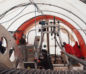 Expeditioners inside hot water drill tent