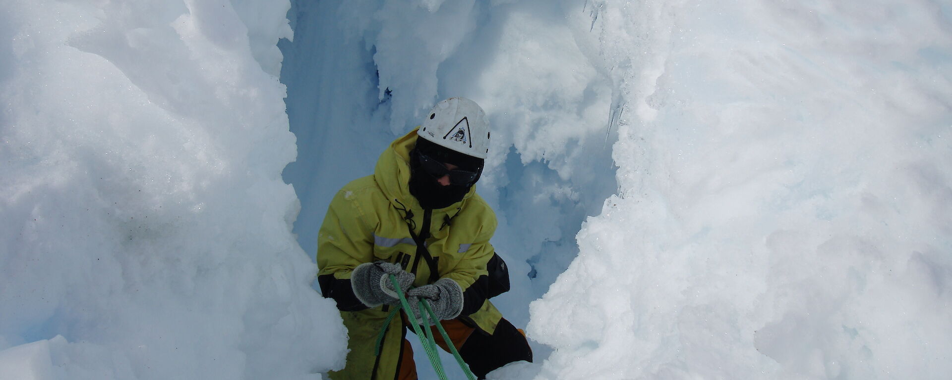 Expeditioner lowered down at a crevasse during field training near Mawson.