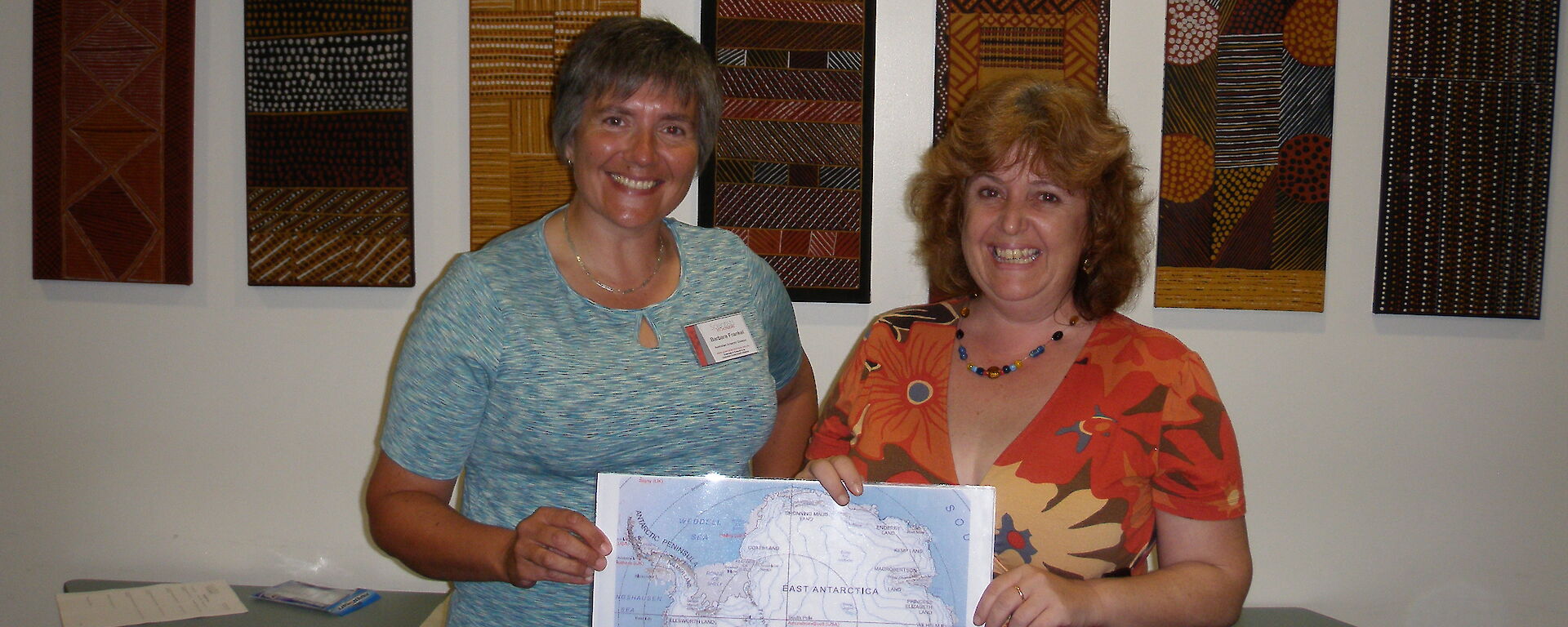 Scientist and teacher at Girraween Primary School pose with map of Antarctica