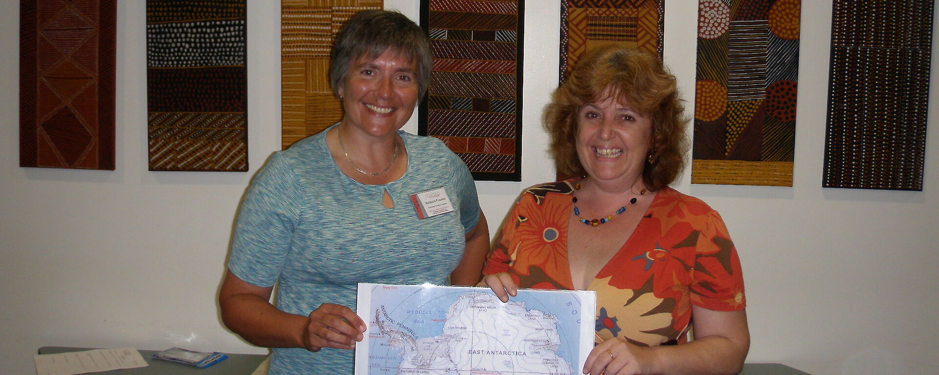Scientist and teacher at Girraween Primary School pose with map of Antarctica