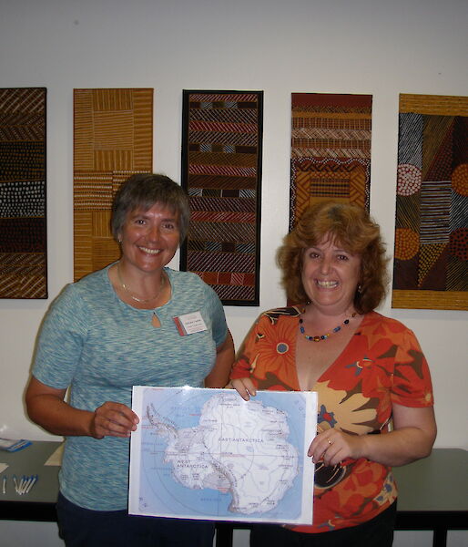 Scientist and teacher at Girraween Primary School pose with map of Antarctica