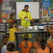 Scientist in a freezer suit demonstrating to school students how to make glacier goo