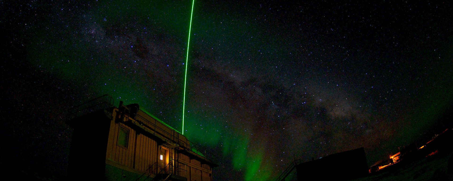 Aurora at Davis with LIDAR beam arcing in the sky above