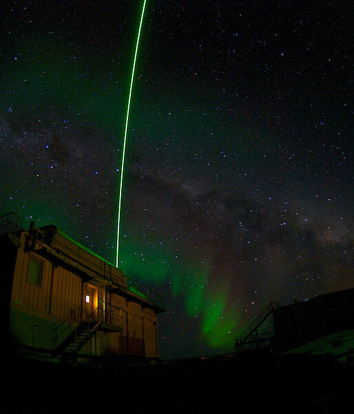 Aurora at Davis with LIDAR beam arcing in the sky above