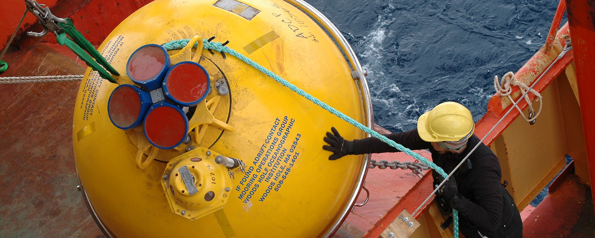 A giant yellow buoy is deployed from the ship’s trawl deck