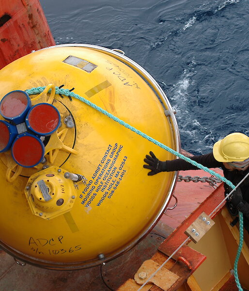 A giant yellow buoy is deployed from the ship’s trawl deck