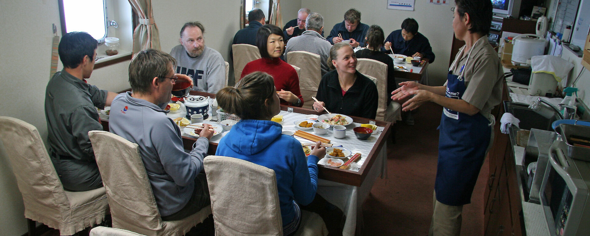 A United Nations of scientists share dinner on the Umitaka Maru.