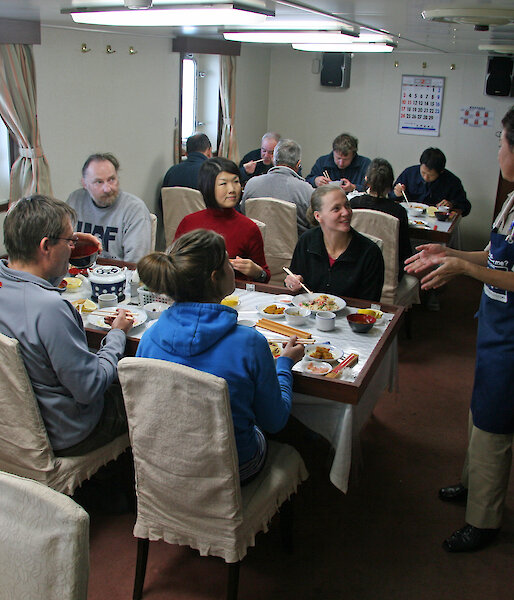 A United Nations of scientists share dinner on the Umitaka Maru.