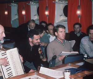 Phil Law playing the accordion on the Nella Dan, ca. 1965