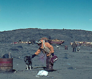 Phil Law on the beach at Davis in 1963, with the huskies and his Qantas bag.