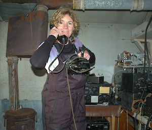 Jo in the communications building, testing an old phone that was still in good working order.