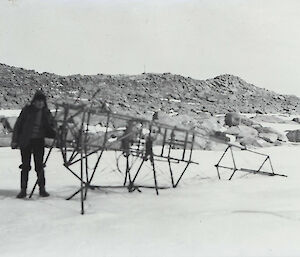 Vintage photo of a man in the snow with a wire frame
