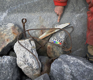 Small bit of wire and canvas from air tractor frame, an expeditioner points to it