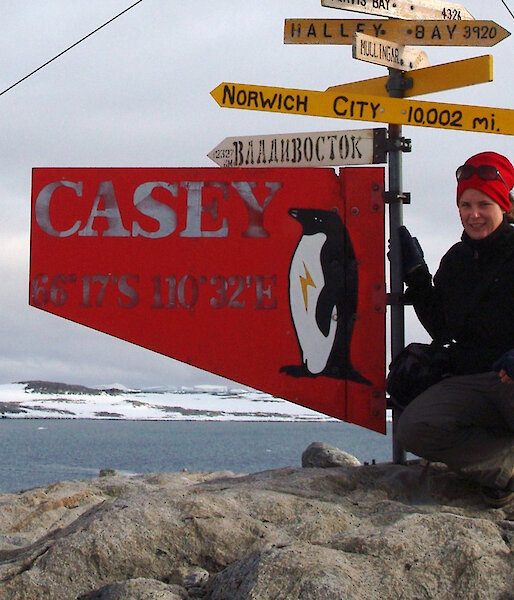 Susan Doust beside the signpost at Casey station.