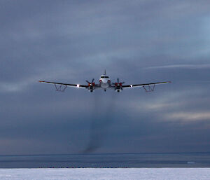 The Basler BT-67 aircraft with wing-mounted ice penetrating radar antennae, approaching the Casey ski landing area.