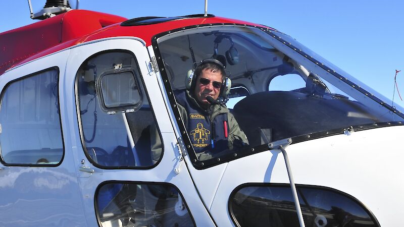 David Pullinger in his helicopter in Antarctica
