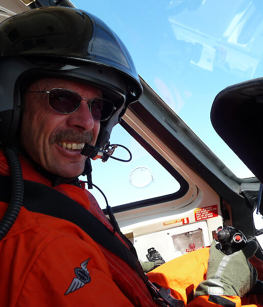Pilot at the controls of helicopter