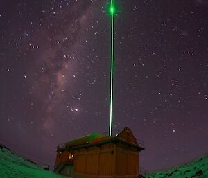 LIDAR light pulse emitting from Davis Station with Milky Way evident in the sky above