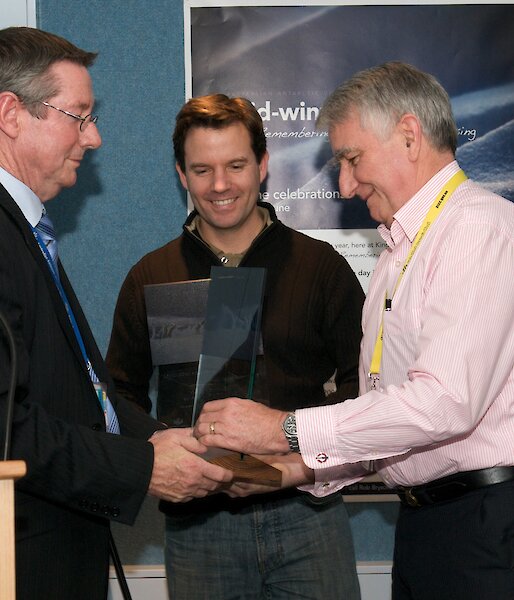 Director presenting award for the Casey and Wilkins summer crew.