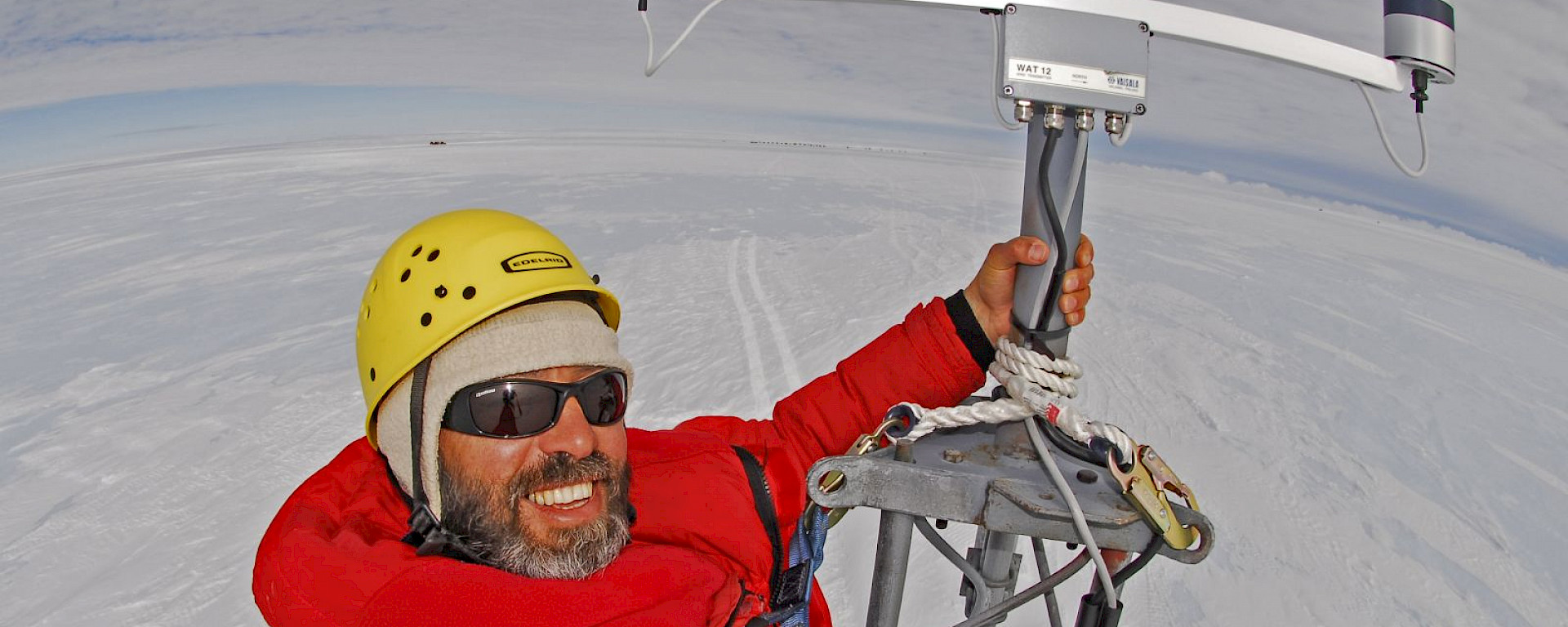 Todor Iolovski atop an automatic weather station