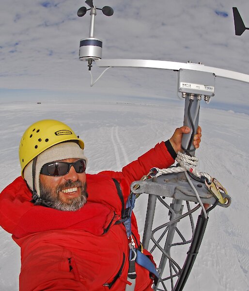 Todor Iolovski atop an automatic weather station