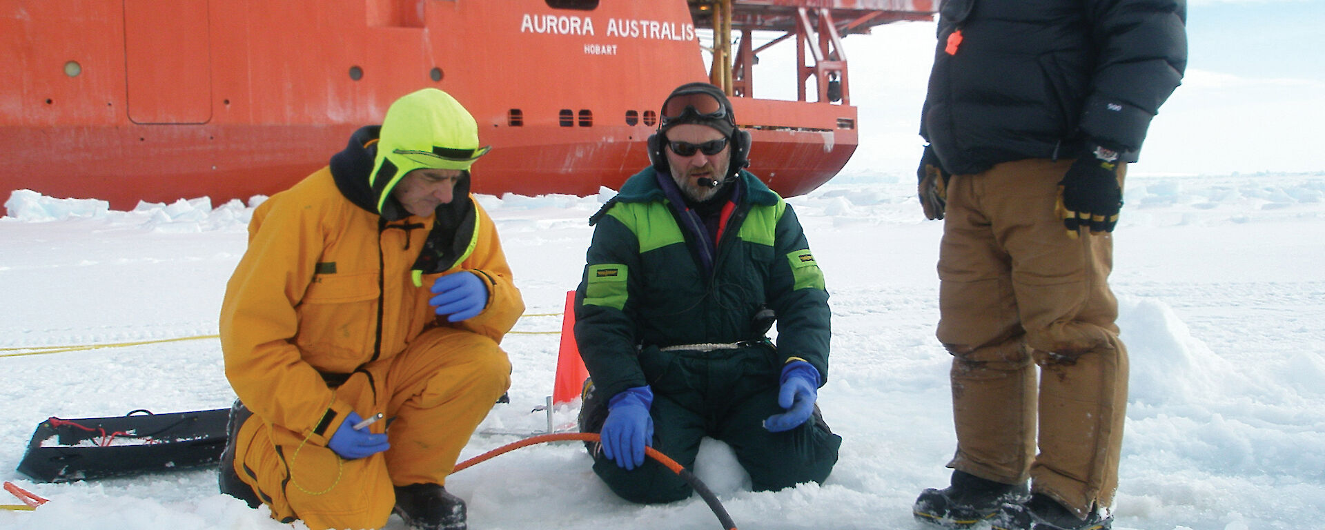 Marine Science Support members deploy a Remotely Operated Vehicle through a drill-hole during SIPEX