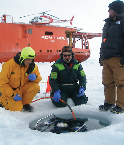 Marine Science Support members deploy a Remotely Operated Vehicle through a drill-hole during SIPEX.