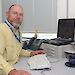 Man seated at desk in office with computer equipment