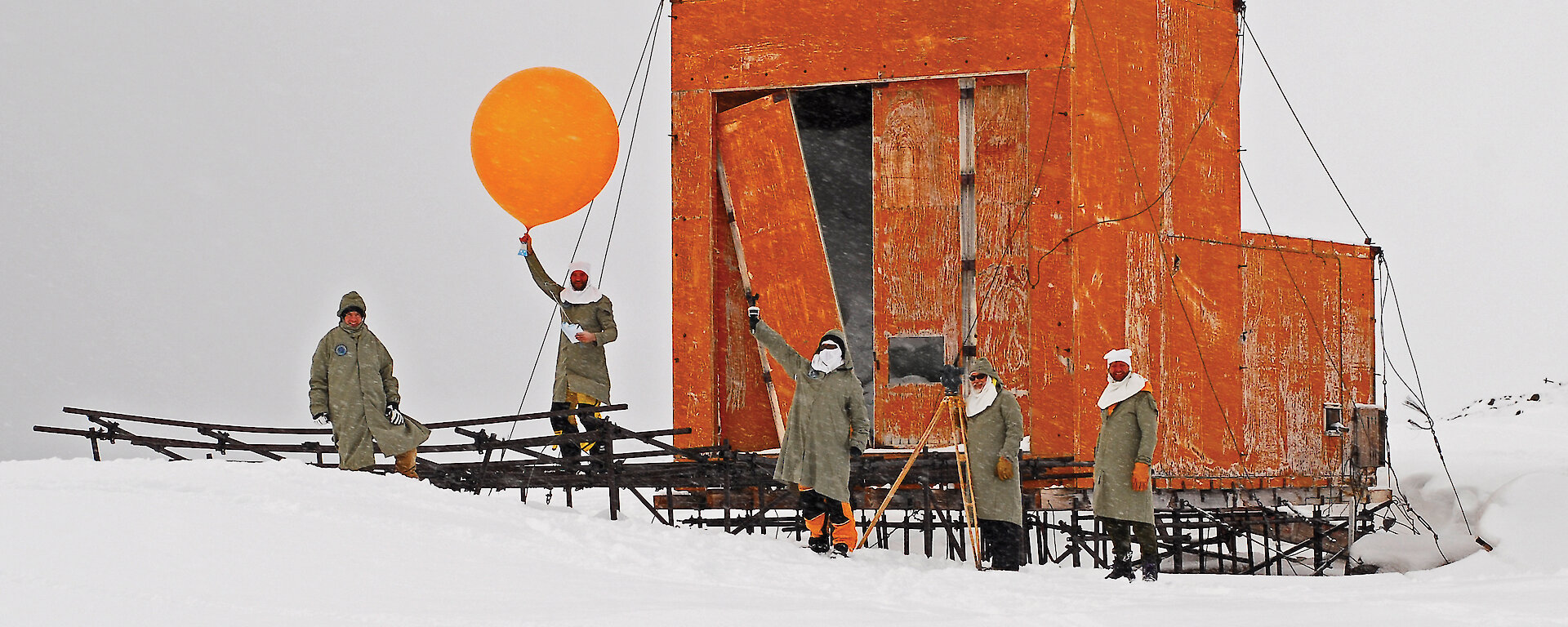 Expeditioners releasing a commemorative weather balloon from the old Wilkes balloon shed.