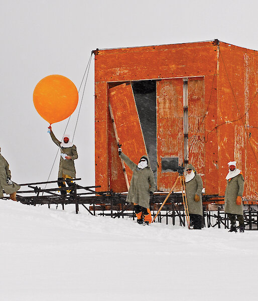 Expeditioners releasing a commemorative weather balloon from the old Wilkes balloon shed.