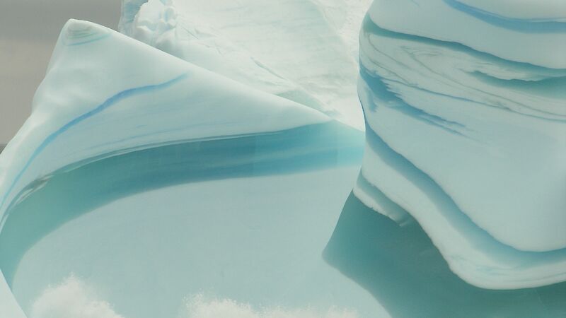 Iceberg with layers of green ice