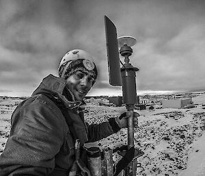 Alex climbs an anemometer tower to service the equipment, which is used to measure wind speed.