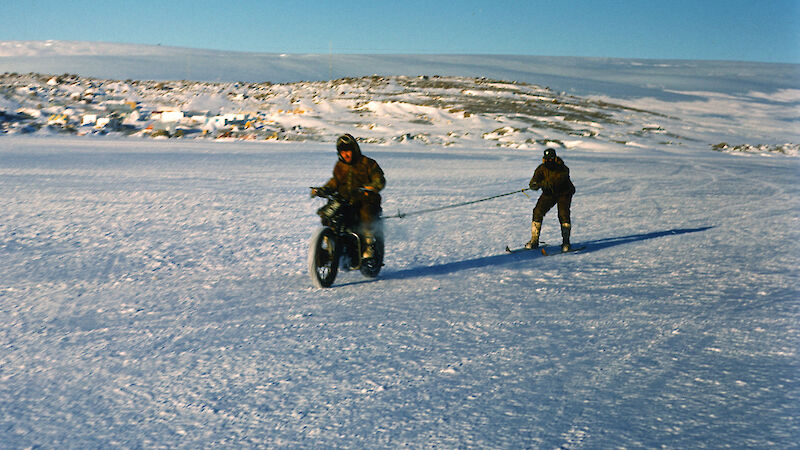 Bill Kellas and George Cresswell take the Velocette for a spin on Horseshoe Harbour.