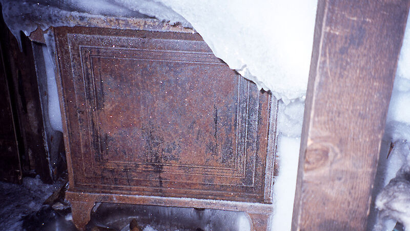 One side of the stove in Mawson's main hut is visible through ice and other detritus, when uncovered in 2002.