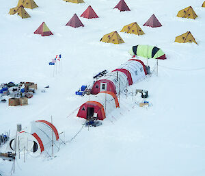 The Aurora Basin campsite viewed from the air showing small polar pyramid tents and longer equipment tents