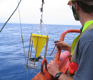 A time-series sediment trap being deployed off the side of the ship by Mr Stephen Bray