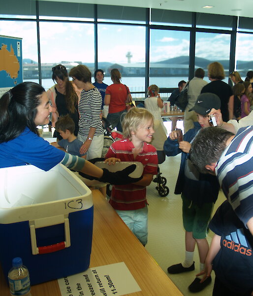 IMAS PhD student Mana Inoue shows an Antarctic ice core to children and parents