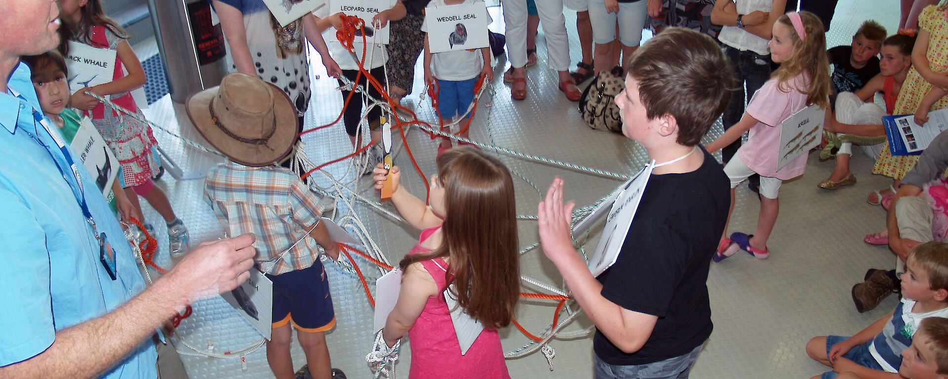 Children get tangled in the food web game during the Pubic Open Science Day