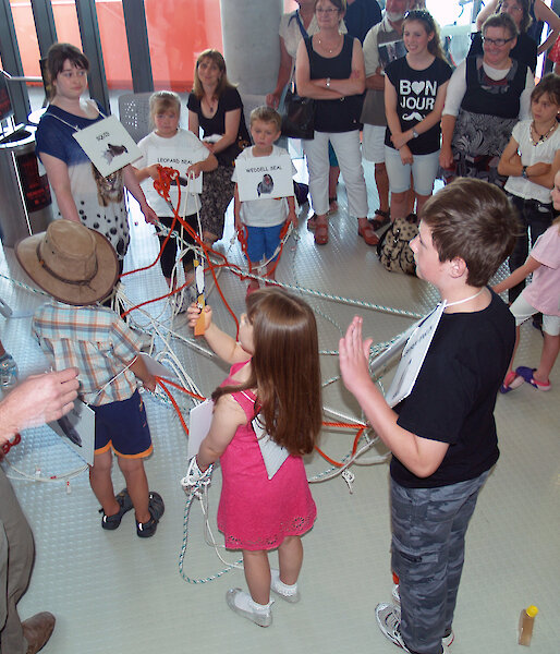 Children get tangled in the food web game during the Pubic Open Science Day