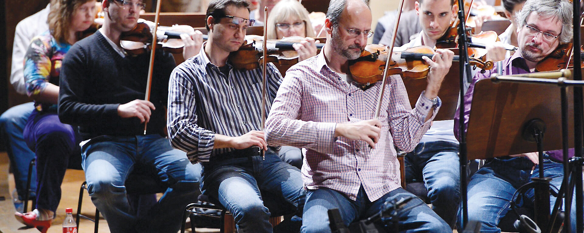 Musicians play composer Matthew Dewey’s symphony.