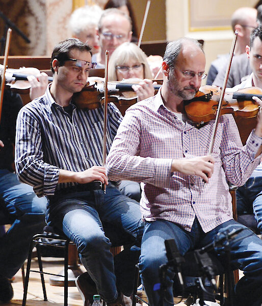 Musicians play composer Matthew Dewey’s symphony.
