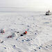 Aerial view of large tents set up on the sea ice for a diver team and remotely operated vehicle team.