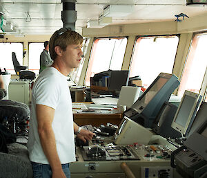 Scott Laughlin at the helm of the Aurora Australis.