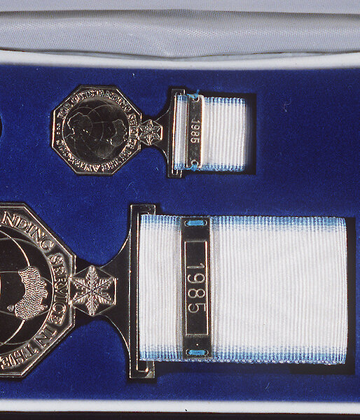 The Australian Antarctic Medal is presented in a box containing: a ‘ribbon bar’, for those in the uniformed services to wear on their uniforms; a miniature medal for wearing with formal evening dress; a lapel badge for everyday wear; and the full-sized medal for wearing on appropriate occasions during the day. The full sized medal has the recipient’s name stamped on the rim.