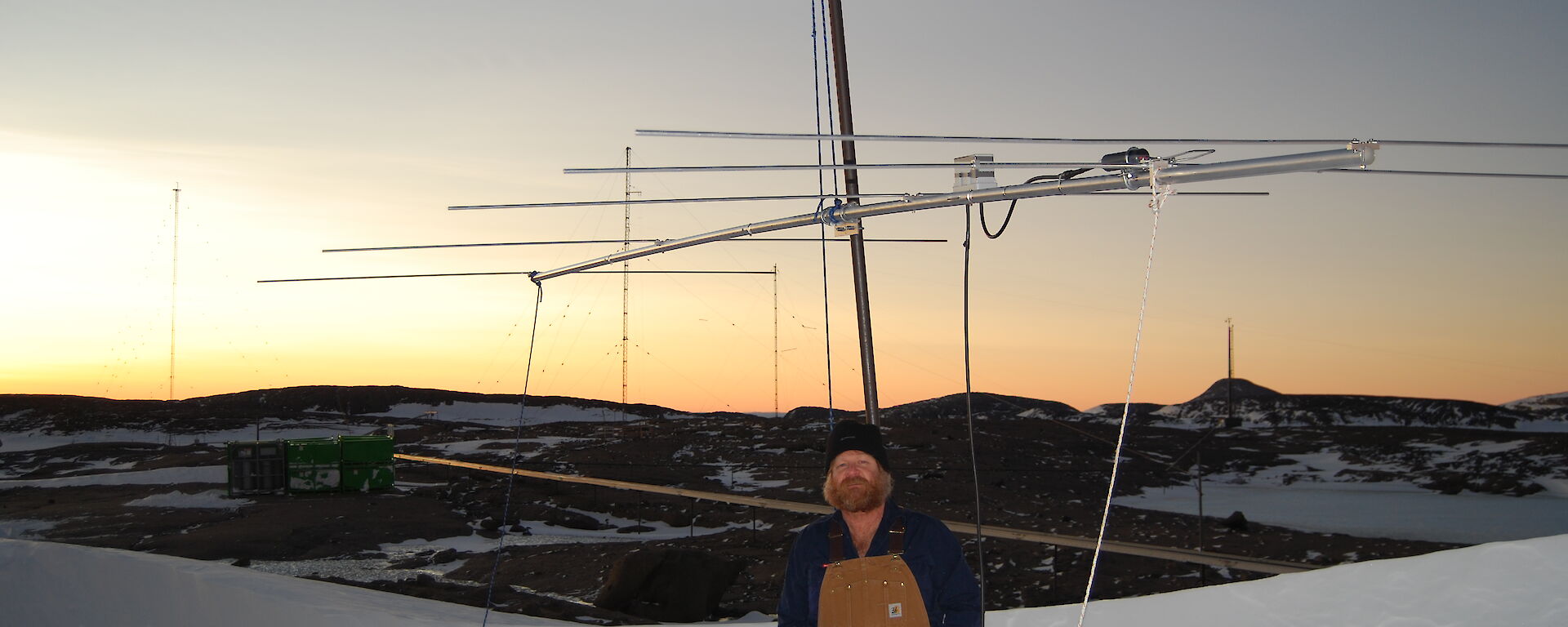 Craig stands in front of the antenna used to bounce a radio signal off the moon.