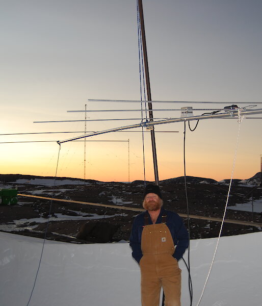Craig stands in front of the antenna used to bounce a radio signal off the moon.