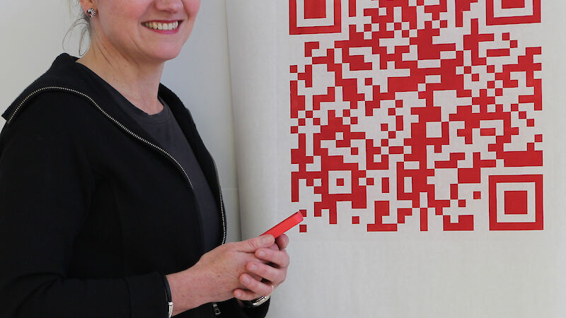 A series of QR (Quick Response) codes printed on rice paper, as part of the Dissolve exhibition, allows viewers to scan the codes with their smart devices and link to web sites about pteropods and ocean acidification. Here Melissa stands in front of a code entitled Under Threat.
