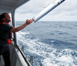 Scientists deploy a directional sonobuoy from the ship.