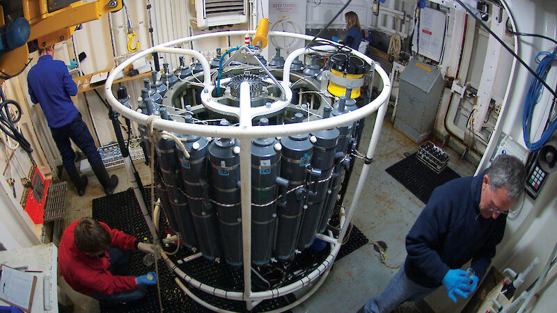 Dr Steve Rintoul (front right) and other scientists take samples collected by the CTD (conductivity, temperature and depth instrument).