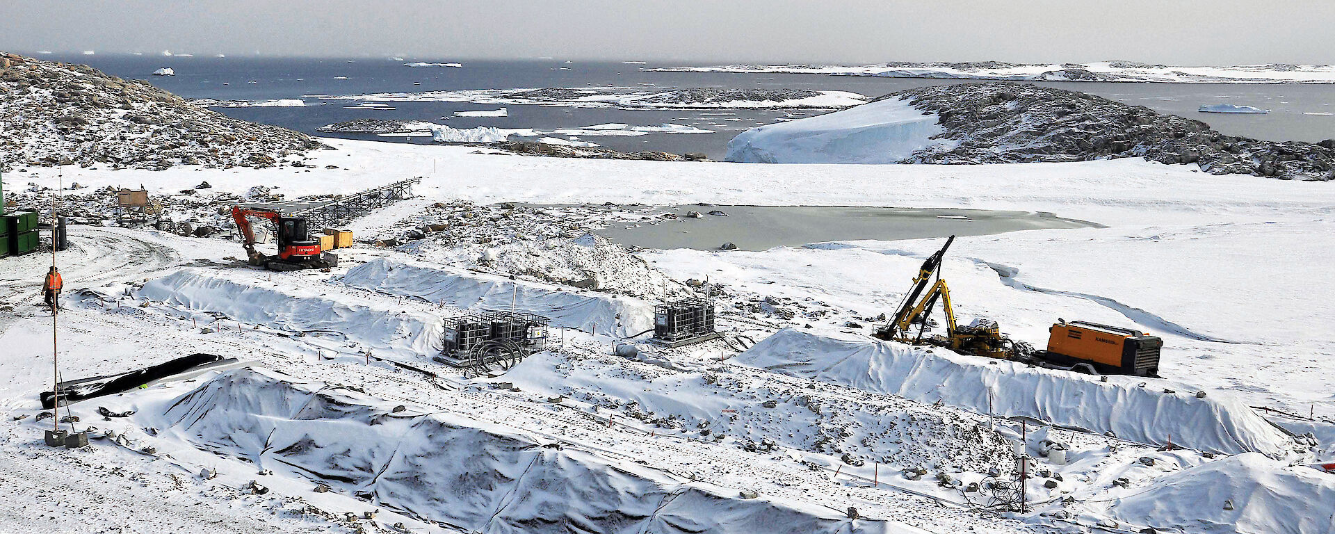 Piles of soil known as ‘biopiles’ under a protective covering in the snow at Casey station.